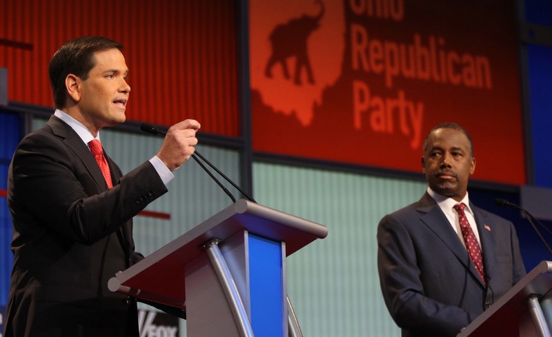 Republican presidential candidate Sen. Marco Rubio, R-Fla., speaks as Ben Carson listens during the first Republican presidential debate. CREDIT: AP PHOTO/ANDREW HARNIK