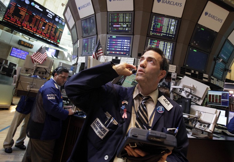 Trader Gregory Rowe works on the floor of the New York Stock Exchange CREDIT: AP PHOTO/RICHARD DREW