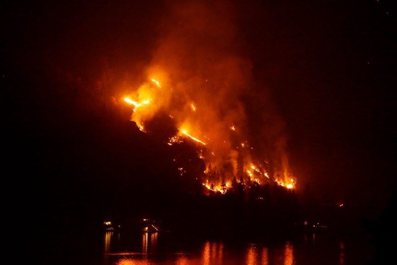 Timber burns in the First Creek fire near lakeside structures on the western shore of Lake Chelan late Monday, Aug. 17, 2015, near Chelan, WA. CREDIT: AP PHOTO/TED S. WARREN