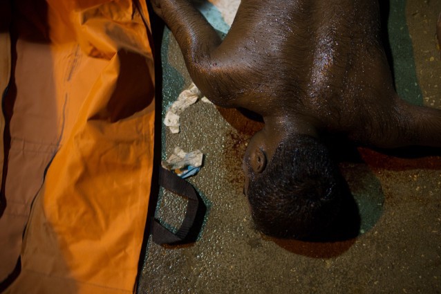 In this Thursday, Aug. 27, 2015 photo, the body of a drowned migrant lies on the ground after his boat sank off the coast of in Zuwara, Libya. It was not clear how many migrants had drowned. CREDIT: AP Photo/Mohamed Ben Khalifa