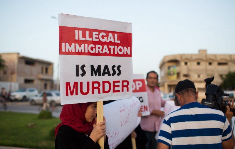 Local residents hold a demonstration against illegal immigration after hearing news that a boat carrying hundreds of migrants capsized off the coast, in Zuwara, Libya. CREDIT: AP PHOTO/MOHAMED BEN KHALIFA