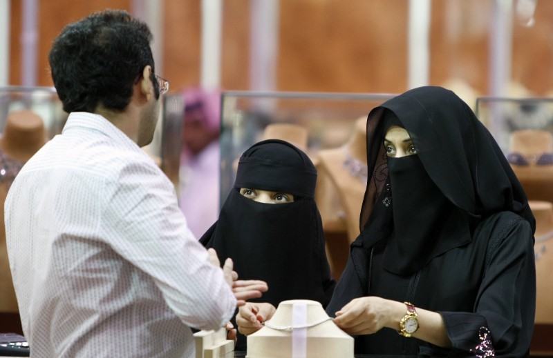 Saudi women look at jewelry at a gold fair in Riyadh, Saudi Arabia. CREDIT: AP/HASSAN AMMAR