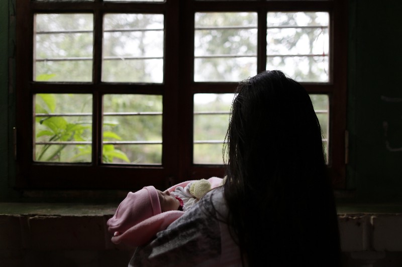 A 13-year-old girl holds her one-month old baby at a shelter for troubled children in Ciudad del Este, Paraguay CREDIT: AP PHOTO/JORGE SAENZ