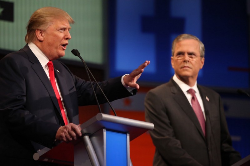 Republican presidential candidate Donald Trump, left, speaks as Jeb Bush listens during the first Republican presidential debate at the Quicken Loans Arena Thursday, Aug. 6, 2015, in Cleveland. CREDIT: AP PHOTO/ANDREW HARNIK