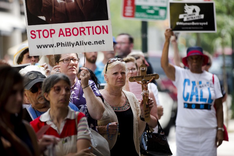 Anti-abortion activists demonstrate outside a Planned Parenthood clinic in Philadelphia, calling for an end to government funding for the nonprofit reproductive services organization CREDIT: AP PHOTO/MATT ROURKE