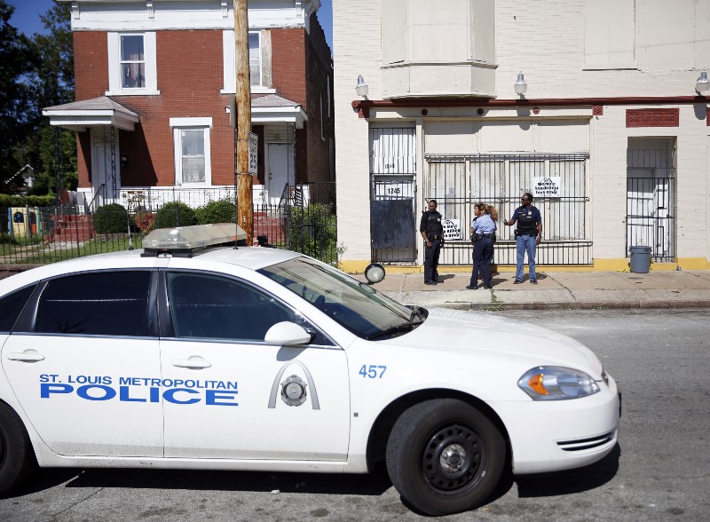Police stand by the site where Mansur Ball-Bey was shot on August 20. CREDIT: AP PHOTO/JEFF ROBERSON
