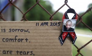 A ribbon with the image of Walter Scott is affixed to the fence at the scene where Scott was fatally shot. CREDIT: AP Photo/David Goldman