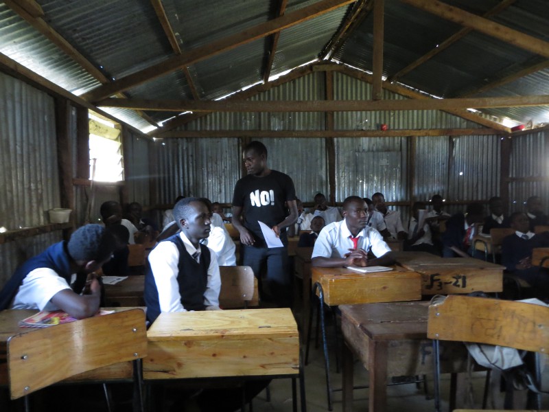 Michael Osore administers a survey on sexual violence to a classroom of high school boys in the Nairobi, Kenya slum of Kawangware. CREDIT: BEENISH AHMED