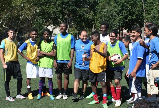 Members of the South Bronx United soccer team holding a soccer ball that they will present to Pope Francis. CREDIT: Esther Yu-Hsi Lee