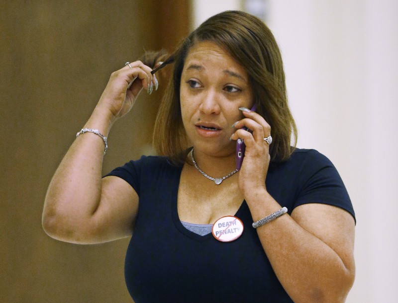 Ericka Glossip-Hodge, the daughter of death row inmate Richard Glossip, talks on the phone following a news conference by his attorneys in Oklahoma City. CREDIT: AP PHOTO/SUE OGROCKI