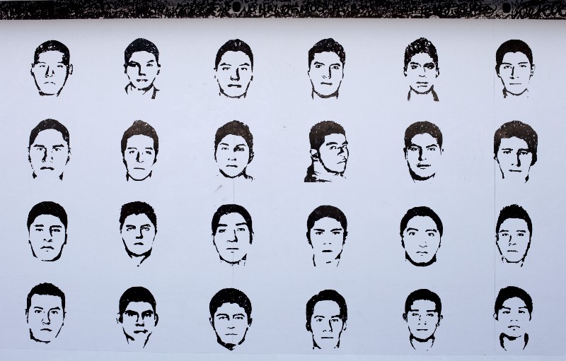 Portraits of some of the 43 missing teacher’s college students are depicted on an Amnesty International billboard erected inside a protest camp where relatives were rallying, in the Zocalo, Mexico City’s main square, Wednesday, Sept. 23, 2015. CREDIT: AP PHOTO/REBECCA BLACKWELL