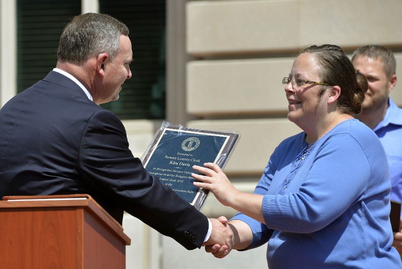 Rowan County, Kentucky, clerk Kim Davis accepts an accolade from a Baptist pastor supportive of her fight CREDIT: AP PHOTO/TIMOTHY D. EASLEY
