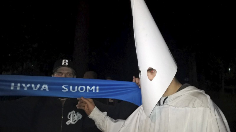 A demonstrator wearing an outfit in the style of the Ku Klux Klan during a demonstration against refugees in Lahti, Finland, late Thursday September 24, 2015. CREDIT: MARKUS LUUKKONEN/LEHTIKUVA VIA AP