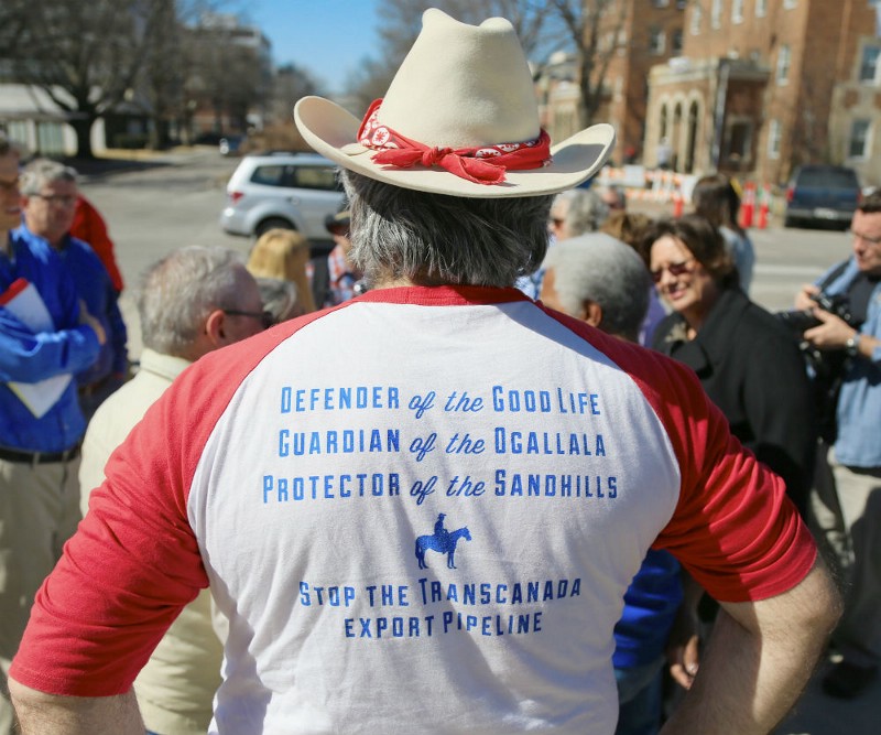 Anti-pipeline activist Allen Schreiber of Lincoln wears a shirt inscribed with slogans opposing the Keystone XL pipeline during a rally outside the State Capitol in Lincoln, Neb. CREDIT: AP PHOTO/NATI HARNIK