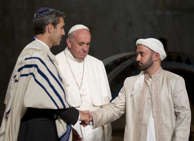 Pope Francis looks on as Imam Khalid Latif, right, and Rabbi Elliot J. Cosgrove, left, shake hands at an interfaith service at the September. 11 memorial museum. CREDIT: (AP Photo/Alessandra Tarantino