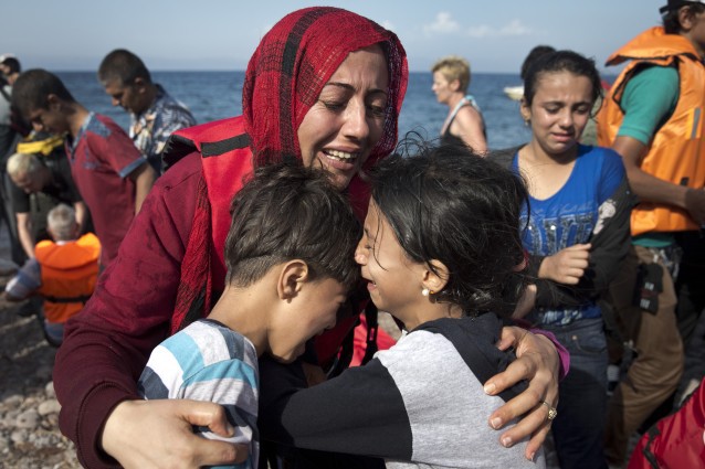 A Syrian woman embraces her children after they arrived from Turkey to Lesbos island, Greece, on a dinghy, Friday, Sept. 11, 2015. CREDIT: AP Photo/Petros Giannakouris