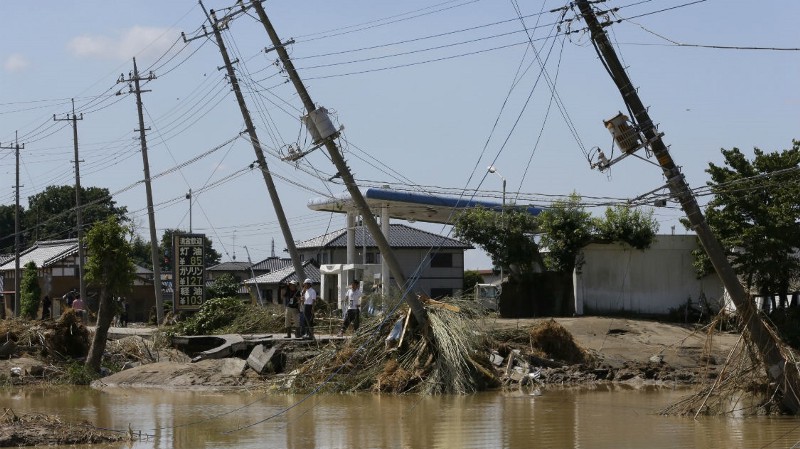 Electric poles tilt damaged after floods hit Joso, Ibaraki prefecture, northeast of Tokyo, Friday, Sept. 11, 2015. CREDIT: AP PHOTO/SHIZUO KAMBAYASHI