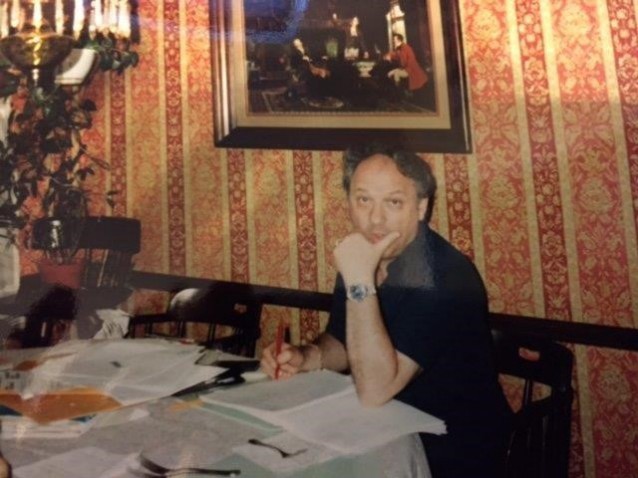 Henri Adier grading papers at the kitchen table CREDIT: David Adier
