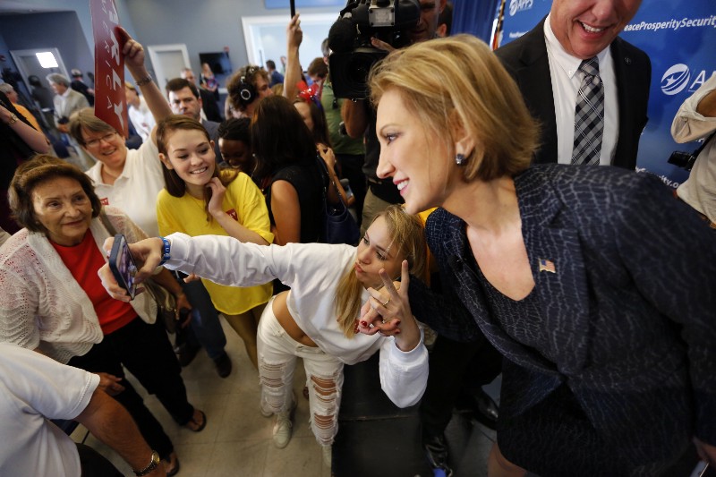 Republican presidential candidate, businesswoman Carly Fiorina, poses for a photo with a supporter after a town hall meeting concerning foreign affairs, Tuesday, Sept. 22, 2015, at Johnson Hagood Stadium on the campus of The Citadel in Charleston, S.C. CREDIT: AP PHOTO/MIC SMITH