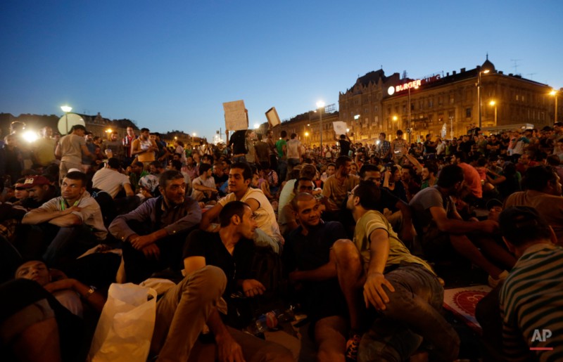 Refugees wait in Budapest CREDIT: PETR DAVID JOSEK, AP