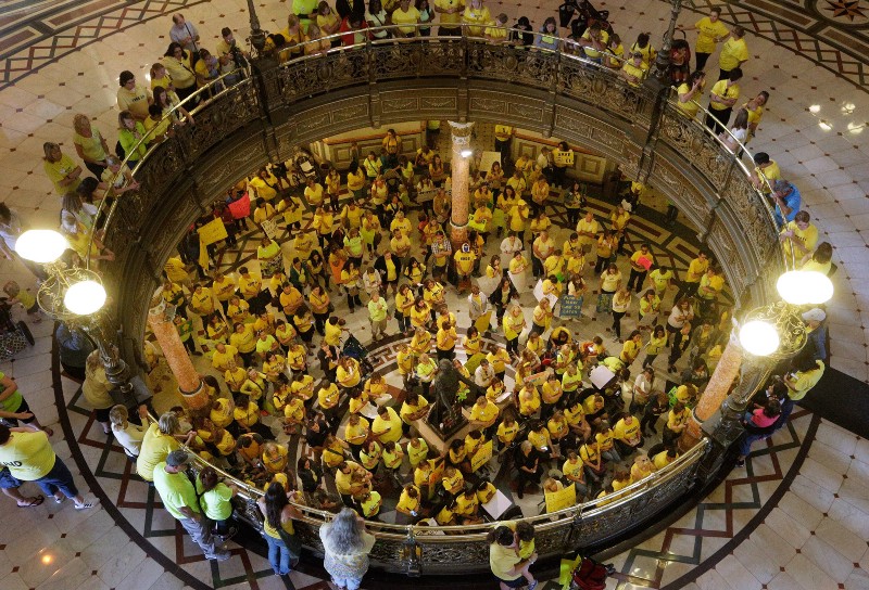 Supporters of Early Intervention programs rally for the continuing of funding from the state in the rotunda at the Illinois State Capitol, Thursday, Sept. 24, 2015, in Springfield, Ill. CREDIT: AP PHOTO/SETH PERLMAN
