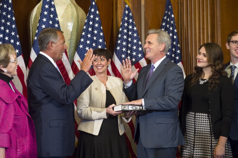 House Speaker John Boehner of Ohio administers a ceremonial re-enactment of the House oath-of-office to House Majority Leader Kevin McCarthy of Calif., accompanied by his family, Tuesday, Jan. 6, 2015, on Capitol Hill in Washington. CREDIT: AP PHOTO/CLIFF OWEN