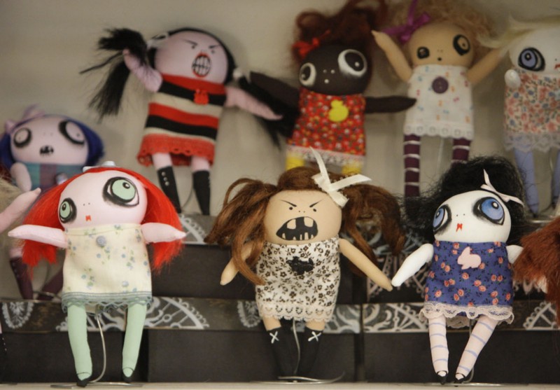 Handmade dolls sit on a consignment store shelf. CREDIT: AP PHOTO/M. SPENCER GREEN
