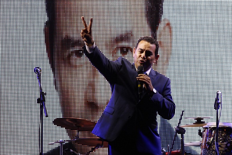 Television comedian Jimmy Morales, flashes a victory sign to his supporters at his party headquarters in Guatemala City, Sunday, Sept. 6, 2015. CREDIT: AP PHOTO/LUIS SOTO