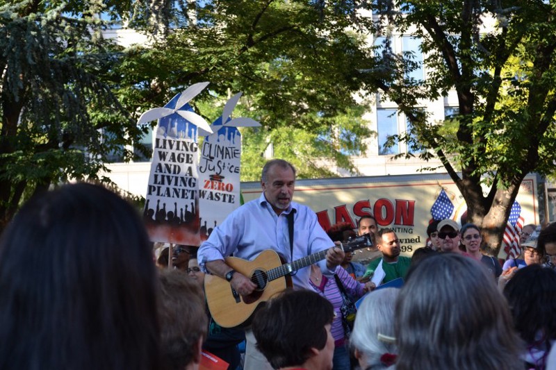 David Mott playing guitar to the crowd of protesters at Franklin Park CREDIT: Jess Colarossi