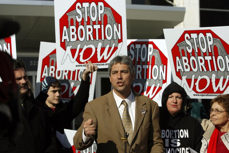 Operation Rescue President Troy Newman, center, speaks to the media during a press conference outside the Sedgwick County Courthouse CREDIT: AP PHOTO/LARRY W. SMITH
