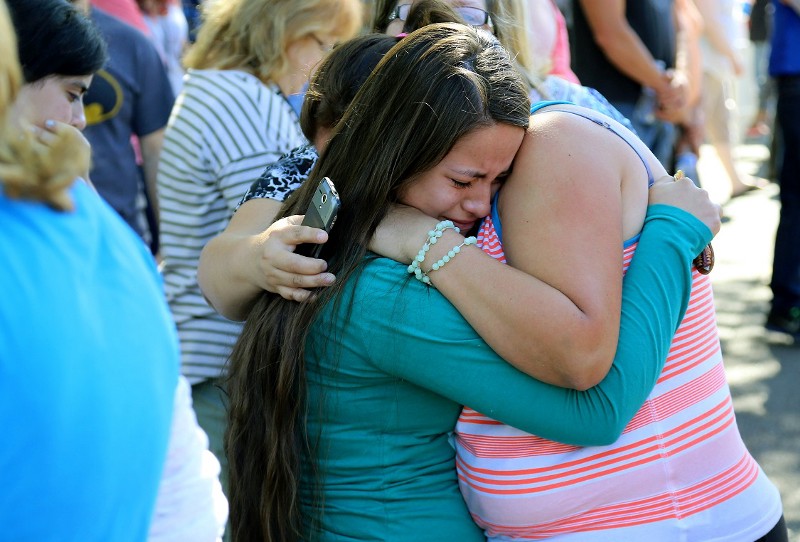 Jessica Vazquez, left, hugs her aunt Leticia Acaraz as they await word on Acaraz’s daughter at the local fairgrounds after a shooting at Umpqua Community College in Roseburg, Oregon CREDIT: AP PHOTO/RYAN KANG
