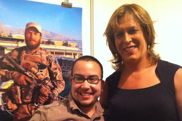 Mitch Kellaway and retired Navy Seal Kristin Beck, standing in front of an image of Beck before she transitioned. CREDIT: Facebook/Mitch Kellaway