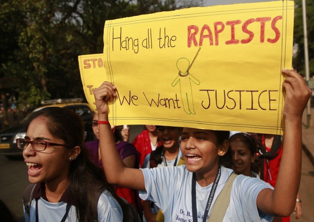 Indian students hold placards and shout slogans during a protest organized to create awareness on gender- based violence on women in Mumbai, India, Wednesday, Dec 10, 2014. The alleged rape by a driver of a taxi-booking service Uber in New Delhi last week, almost two years after a young woman was fatally gang raped on a bus in the capital, has renewed national anger over sexual violence in India and demands for more effort to ensure women’s safety. (AP Photo/Rafiq Maqbool) CREDIT: AP Photo/Rafiq Maqbool