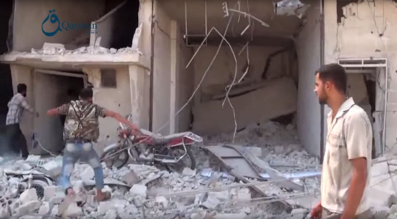 In this Thursday, Oct. 1, 2015, image taken from video provided by the Syrian activist-based media group Qasioun News, which has-been verified and is consistent with other AP reporting, Syrians gather near the rubble of a building, in the aftermath of a Russian airstrike, in Dair al-Asafeer village, rural Damascus, Syria. Russian fighter jets have kept up a sustained rhythm of airstrikes since Wednesday. They carried out 18 sorties in the past 24 hours, including 10 overnight in which seven sites were bombed, the Defense Ministry said Friday. CREDIT: QASIOUN NEWS VIA AP VIDEO