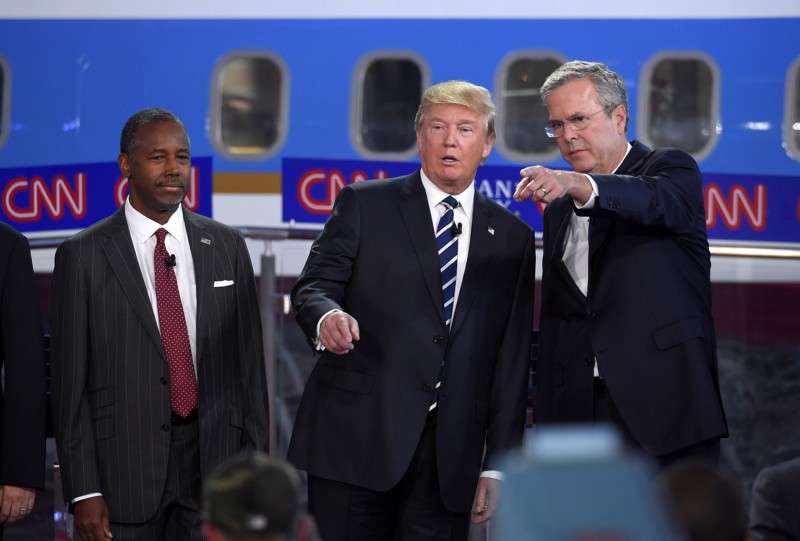 Republican presidential candidates, from left, Ben Carson, Donald Trump, and former Florida Gov. Jeb Bush chat during the CNN Republican presidential debate at the Ronald Reagan Presidential Library and Museum, Wednesday, Sept. 16, 2015, in Simi Valley, Calif. CREDIT: AP PHOTO/MARK J. TERRILL)