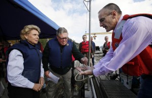 Gov. Chris Gregoire, left, is shown juvenile oysters by Taylor Shellfish spokesman Bill Dewery in 2010. CREDIT: AP Photo/Elaine Thompson