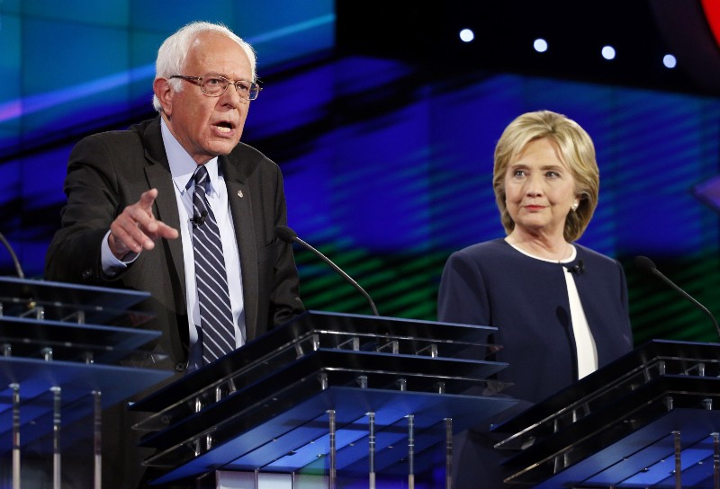 Hillary Rodham Clinton, right, looks on as Sen. Bernie Sanders, of Vermont, speaks during the CNN Democratic presidential debate Tuesday, Oct. 13, 2015, in Las Vegas. CREDIT: AP PHOTO/JOHN LOCHER