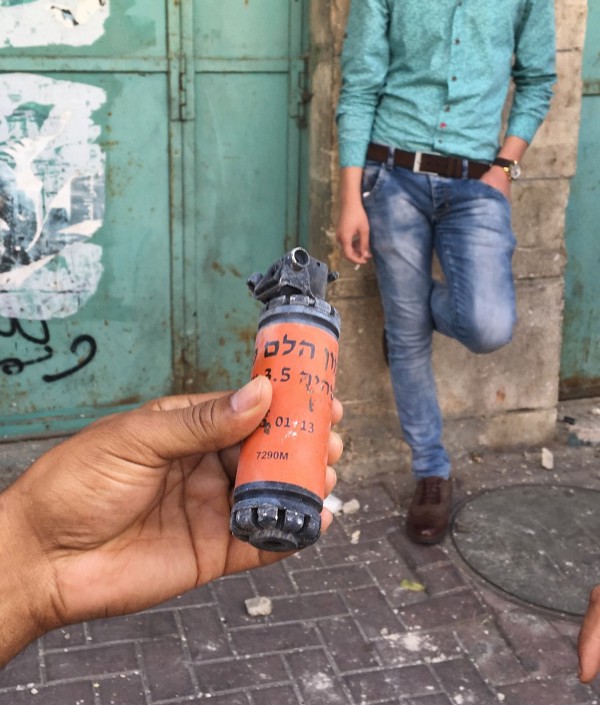 A journalist holds aloft a sound bomb, used to disperse demonstrators in Hebron. CREDIT: Jack jenkins