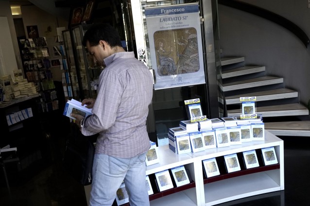 A man looks at a copy of Pope Francis’ encyclical on sale at the Vatican bookshop, in Rome, Thursday, June 18, 2015. CREDIT: AP Photo/Andrew Medichini