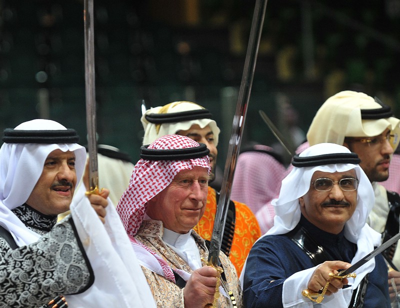 Britain’s Prince Charles, center, wears traditional Saudi uniform as he dances with a sword during Janadriya culture festival at Der’iya in Riyadh, Tuesday, Feb. 18, 2014. CREDIT: AP PHOTO/FAYEZ NURELDINE