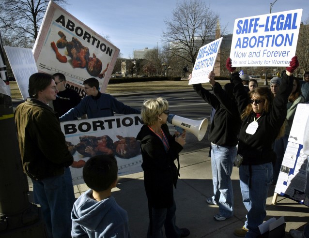 Pro-life and pro-choice supporters face off in front of the State Capitol in Denver CREDIT: AP Photo/Jack Dempsey