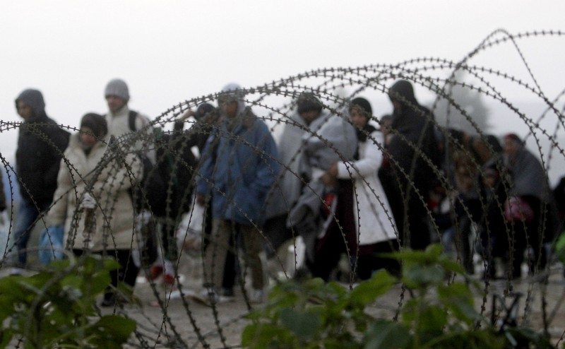 People cross the border from Greece into Macedonia near the southern Macedonian town of Gevgelija, early Saturday, Nov. 14, 2015. Hundreds of thousands of migrants and refugees have passed the last few months through Macedonia, as a part of the Balkan route on their way to more prosperous European Union countries. CREDIT: AP PHOTO/BORIS GRDANOSKI