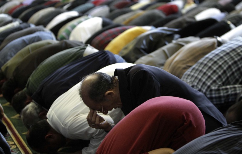 Jebary Alsaade, right, and other Muslims prays at the Islamic Center of America in Dearborn, Mich. CREDIT: AP PHOTO/PAUL SANCYA