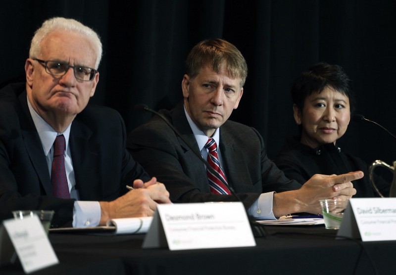 CFPB officials David Silberman, Richard Cordray, and To-Quyen Truong at a hearing about forced arbitration CREDIT: AP PHOTO/BRENNAN LINSLEY