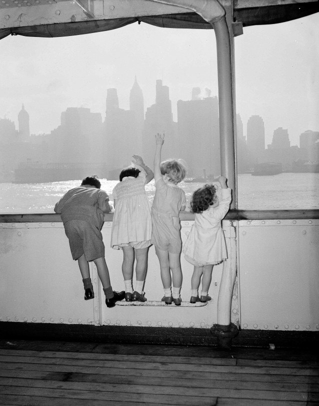 FILE — In this July 1, 1940 file photo, British refugee children, part of a group of 60 under 15 years of age, climb up on the rail of the Holland-America ship Volendam as they approach New York after a voyage from Southampton, England. In the Battle of Britain from June to October 1940, RAF fighters clashed with the German Luftwaffe over the skies of Britain. (AP Photo) CREDIT: AP Photo