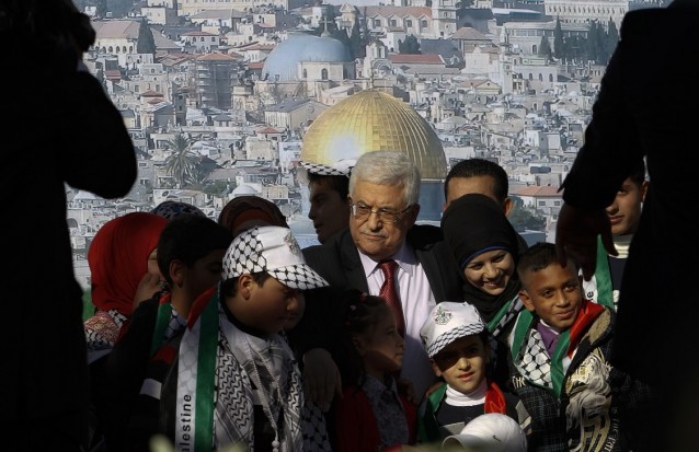 Palestinian President Mahmoud Abbas, center, is surrounded by children during celebrations for the successful bid to win U.N. statehood recognition for Palestine in the West Bank city of Ramallah, Sunday, Dec. 2, 2012. Abbas has returned home to a hero’s welcome after winning a resounding endorsement for Palestinian independence at the United Nations. CREDIT: AP Photo/Nasser Shiyoukhi