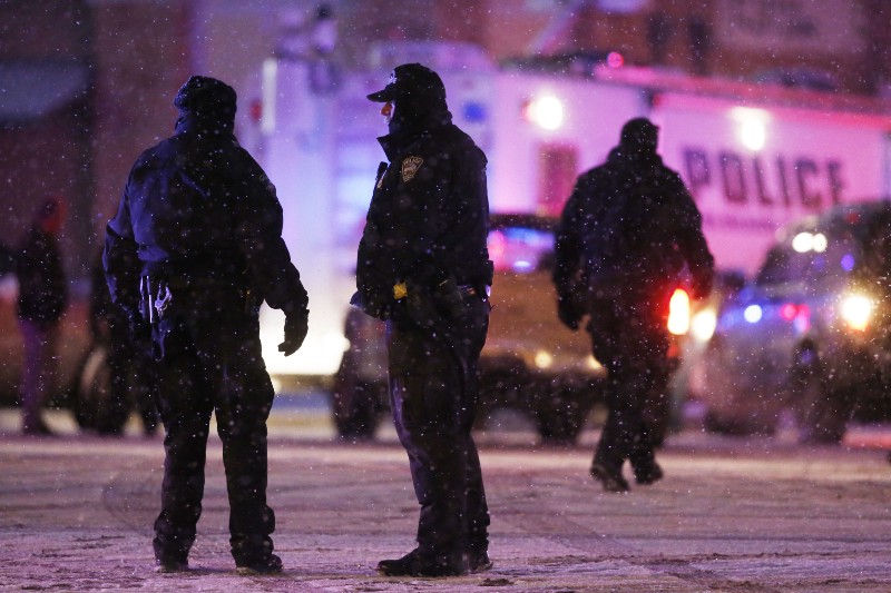 Police confer at an intersection near the scene of a shooting at a Planned Parenthood clinic Friday, Nov. 27, 2015, in Colorado Springs, Colorado. CREDIT: AP PHOTO/DAVID ZALUBOWSKI