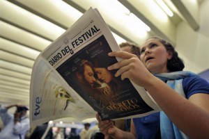 A teenage girl reading a newspaper promoting a Spanish film festival, El secreto de sus ojos on the cover CREDIT: AP Photo/Alvaro Barrientos