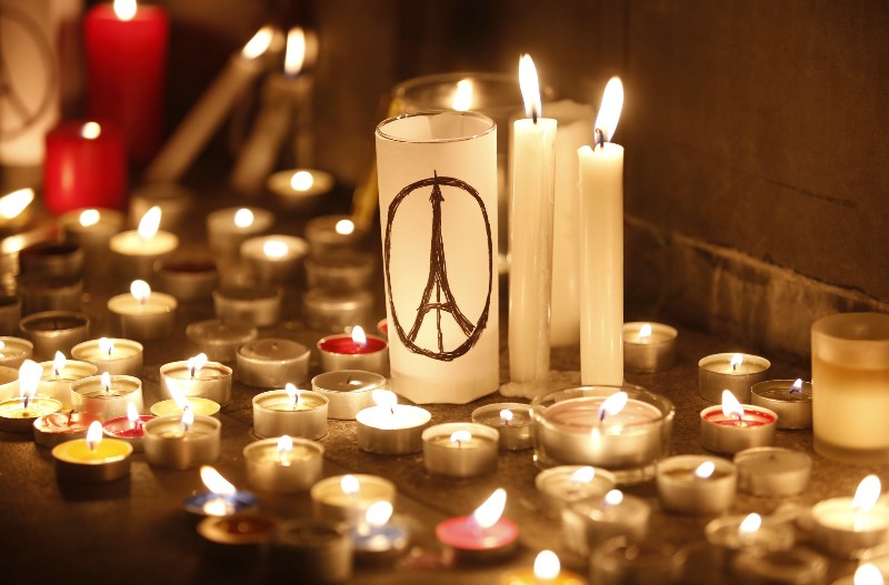 Candles are lit as people gather in Hong Kong, Saturday, Nov. 14, 2015, to mourn for the victims killed in Friday’s attacks in Paris. French President Francois Hollande said more than 120 people died Friday night in shootings at Paris cafes, suicide bombings near France’s national stadium and a hostage-taking slaughter inside a concert hall. (AP Photo/Kin Cheung) CREDIT: AP PHOTO/KIN CHEUNG