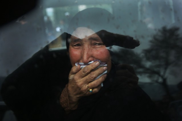 A Hazara tribeswoman cries in a car as thousands march through the Afghan capital of Kabul on Wednesday, Nov. 11, 2015, carrying the coffins of seven ethnic Hazaras who were allegedly killed by the Taliban and calling for a new government that can ensure security in the country. CREDIT: AP Photos/Massoud Hossaini